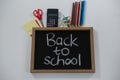 Back to school text on slate with various supplies Royalty Free Stock Photo