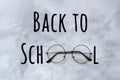 Back to school text and stylish black round eyeglasses spectacles on marble background. Concept education. Top view Greeting card Royalty Free Stock Photo