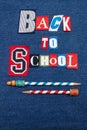 BACK TO SCHOOL text word collage, colorful fabric on blue denim, vintage pencils and copy space