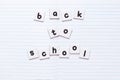 Back to school text written by black printed letters on white sheets of paper on notebook sheet. Education concept Royalty Free Stock Photo