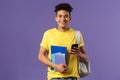 Back to school, university concept. Portrait of cheerful young handsome male student wearing backpack on shoulder, hold Royalty Free Stock Photo