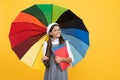 back to school. vivid rain protection. happy girl in glasses hold notebook. education. Royalty Free Stock Photo