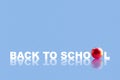 Back to school. Words on a blue background. Apple. Reflection. Copy space. School background. Education background