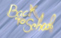 Back to school words lettering made of smoke on blue sand background