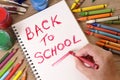 Back to school words written by child holding crayon. Reminder, memo, message concept. Royalty Free Stock Photo