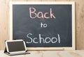 Back to school written on blackboard with tablet Royalty Free Stock Photo