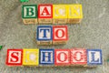 Back to school written with wooden letters on stone Royalty Free Stock Photo