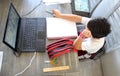 Back to school, 7 year old Latino boy in online home classes with laptop and school supplies Royalty Free Stock Photo