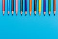 Back to scool - Pencils detail. Colored sharp pencils detail in a row, isolated on blue and yellow