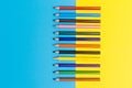 Back to scool - Pencils detail. Colored sharp pencils detail in a row, isolated on blue and yellow