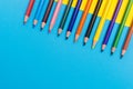 Back to scool - Pencils detail. Colored sharp pencils detail in a row, isolated on blue and yellow