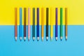 Back to scool - Pencils detail. Colored sharp pencils detail in a row, isolated on blue and yellow