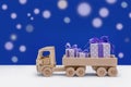 In back of toy car are festive boxes in purple and white polka dots. Royalty Free Stock Photo