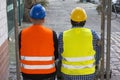 Back turned construction workers looking straight before them Royalty Free Stock Photo