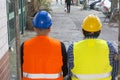 Back turned construction workers looking straight before them Royalty Free Stock Photo