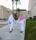 back of two Arabic men walking in Qatar