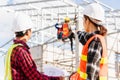 Back two architect and client discussing help create plan with blueprint home building at construction site Royalty Free Stock Photo