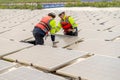 Back of two professional technician worker sit in area of solar cell panel system to work of maintenance process on base over Royalty Free Stock Photo