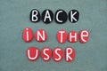 Back in the USSR, creative logo composed with black and red colored stone letters over green sand