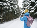 Man in sportswear with backpack shooting on smartphone.