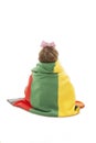Back view of adorable little girl covered with blanket looking at wall. Rear view Royalty Free Stock Photo