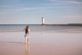 Back view of adorable little girl with long hair in dress walking on tropical beach vacation Royalty Free Stock Photo