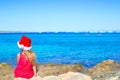 Back view of adorable little girl in Santa hat on Royalty Free Stock Photo