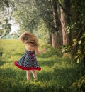 Back view adorable toddler outside in blue and white polka dots Royalty Free Stock Photo