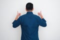 Back view of adult Asian man give two thumbs up Royalty Free Stock Photo