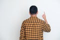 Back view of Adult Asian man ponting finger up Royalty Free Stock Photo