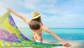 Back view of adult Asian woman wear pink bikini and straw hat relaxing and enjoying holiday at tropical paradise beach. Girl