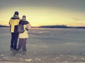 Adult couple holding hands walking on winter beach Royalty Free Stock Photo