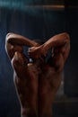 Back view of african american male body builder posing on a black studio background. Beauty and perfection of human body Royalty Free Stock Photo