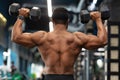 Back view of african american shirtless man exercising at gym Royalty Free Stock Photo