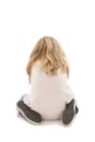 Back view of angry little girl with folded hand, sitting on knees Royalty Free Stock Photo