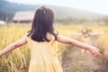 Back view of asian little child girl raise her hand Royalty Free Stock Photo