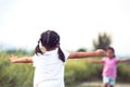 Back view of asian little girl raise her hand Royalty Free Stock Photo