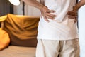 Back view of asian man having a backache,Stressed people suffering from waist pain,lumbar disc herniation,musculotendinous strain, Royalty Free Stock Photo
