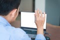 Back view of Asian man speak talk on video call with diverse multiracial colleagues on online meeting on modern laptop at home, Royalty Free Stock Photo