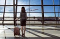 Back view of asian woman carry suitcase in the airport Royalty Free Stock Photo
