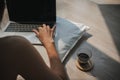 Back view of asian woman using computer, lying on floor while working on laptop with coffee and typing keyboard Royalty Free Stock Photo