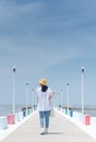 The back view of asian woman walking on the rainbow bridge to see the viewpoint at the Samut Sakorn province, one of the province Royalty Free Stock Photo