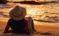 Back view of Asian woman wear bikini and straw hat lying down on sand beach relax and enjoy holiday at tropical beach. Woman watch Royalty Free Stock Photo