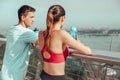 Back view of athletes standing on the bridge after exercising at looking at the city Royalty Free Stock Photo