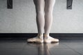 Back view of ballet dancer ballerina at the barre in dance class standing in first position Royalty Free Stock Photo