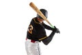 Baseball player, pitcher in a black white sports uniform practicing isolated on a white studio background. Back view