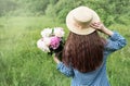 Back view beautiful girl with peonies Royalty Free Stock Photo