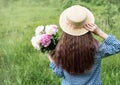 Back view beautiful girl with peonies Royalty Free Stock Photo