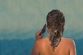 Back view of beautiful naked young woman taking shower in shower cabin. Royalty Free Stock Photo