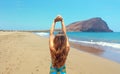 Back view beautiful woman doing stretching exercises on the beach in Playa La Tejita, Tenerife Royalty Free Stock Photo